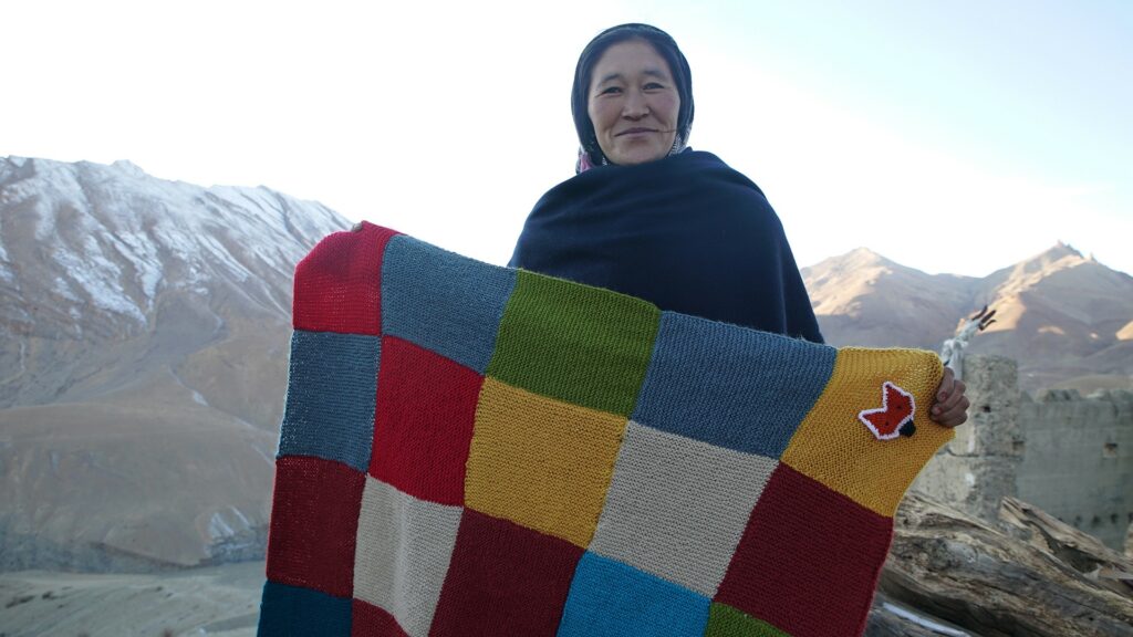 A woman from Kibber posing with her creation.